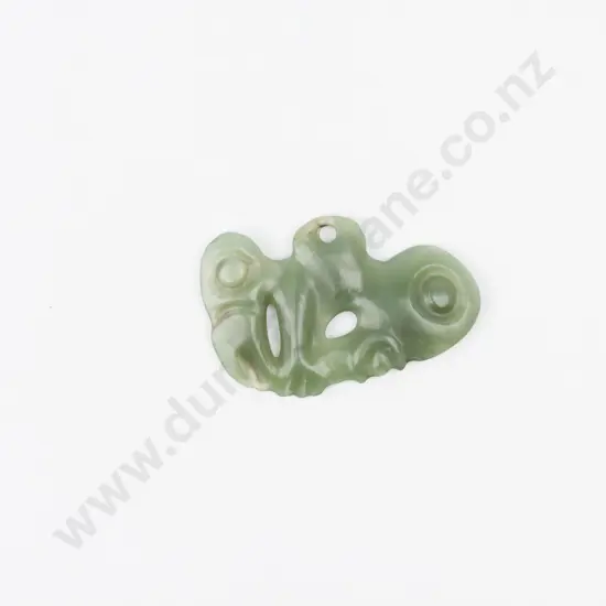 C18th or Earlier Maori Carved Greenstone Pekapeka. The left hand manaia upright as opposed to the near horizontal right hand manaia. Of translucent stone with hour glass form suspension hole. W.6cm