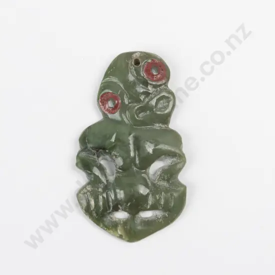 A Late C19th/ Early C20th Maori Greenstone Hei Tiki. Red sealing wax to eyes