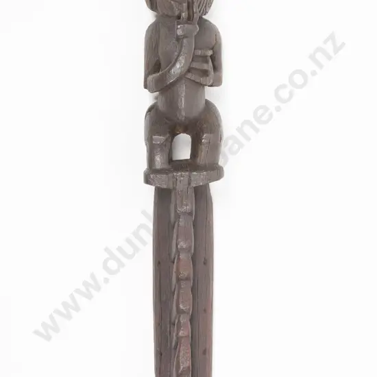 An important C19th or earlier Maori carved wooden tekoteko. The top figure with carved moku to face