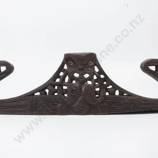 A C19th/ Early C20th Maori Carved Wooden Pare (Lintel). Large manaia figures to each end and pierced central figure with hands to each side of face. Haehae and pakati decoration. Paua shell inset eyes. Lashing holes to reverse