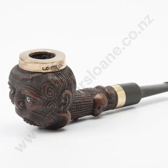 A Late C19th/Early C20th Carved Maori Pipe. The bowl with tattooed face