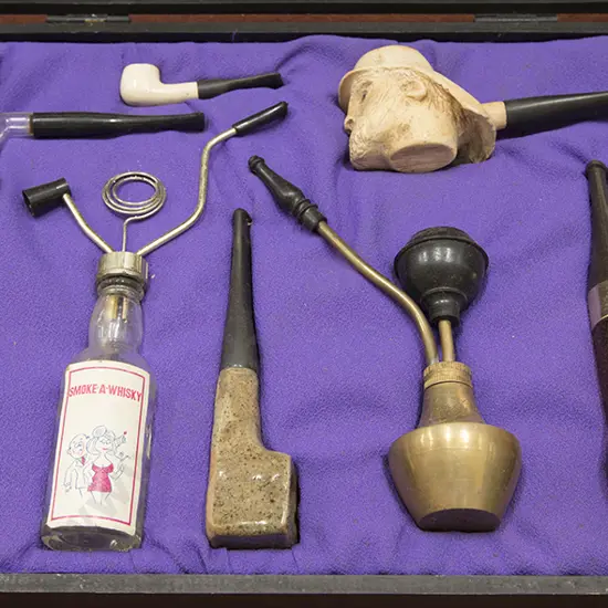 Cased Display Of 8 Various pipes & Novelty Accesories