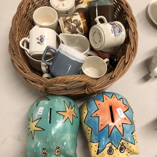 Two Piggy Banks and Basket of NZ Mugs