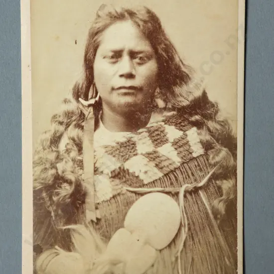Thomas Edward Price Portrait of a Maori woman wearing a korowai holding a kotiate paraoa (whalebone hand club) Carte de visite albumen print