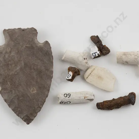 Flint arrowhead and clay pipe fragments