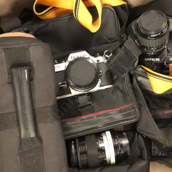 Two Nikon Cameras Together With Assorted Lenses and Cases