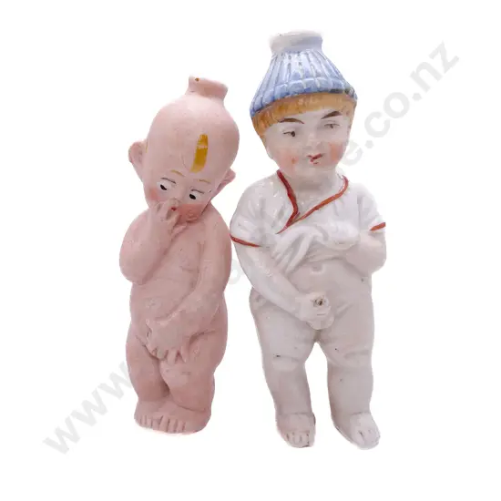 Two All Bisque Character 'Pissing' Dolls