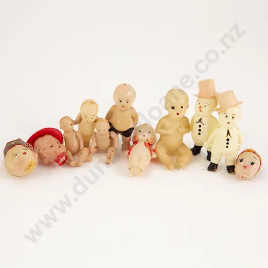 Eight Tiny Celluloid Kewpie and Novelty Dolls
