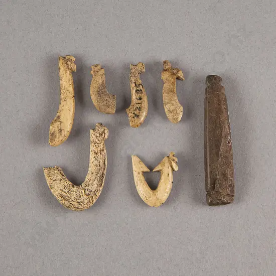 A Stone Minnow Lure And Bone Fish Hook With Fragments