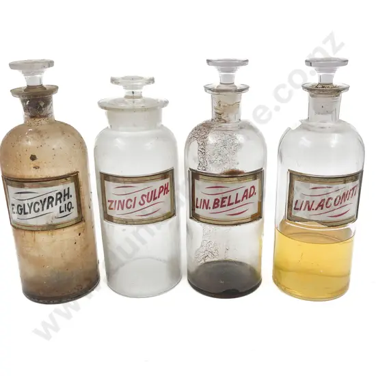 Four Labeled Stoppered Chemist Bottles