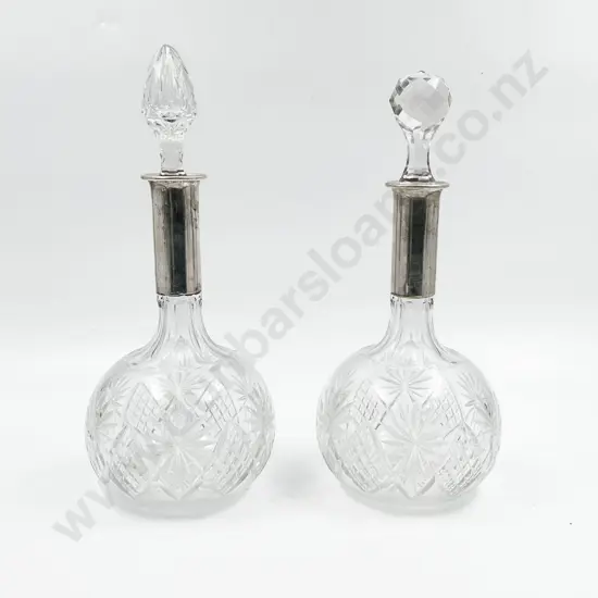 Pair Of Cut Crystal Decanters With .800 Silver Tops one stopper not matching