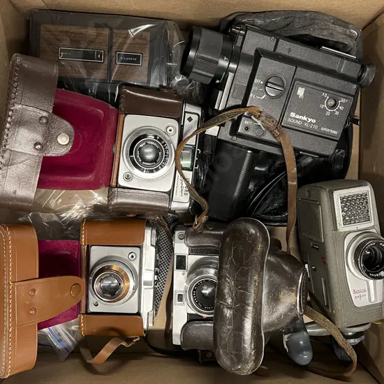 Three Various Film Cameras with Three Cased Cameras