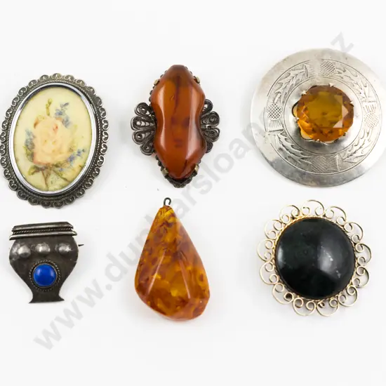 Two Amber Pendants with Four Various Brooches