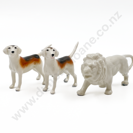 Small Lion Ornament Together with Pair of Beswick Dogs (one with repair to tail)