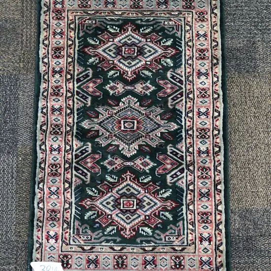Small Persian Mat with Three Lozenge Medallions on Dark Green Ground