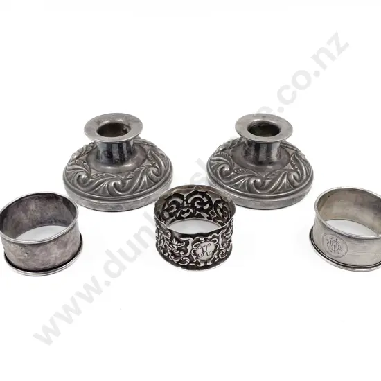 Three S/S Napkin Rings and pair Hecworth silver plate candlesticks