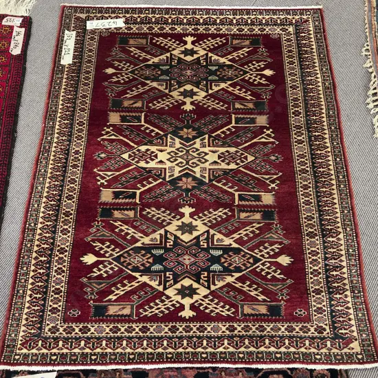Persian rug with Three Central Lozenge Shaped Medallions On a Red Ground