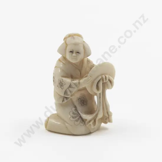 Signed Carved Ivory Netsuke of a Geisha kneeling holding a mirror