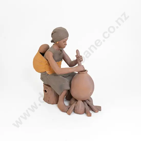 An Ceramic Sculpture Of An African Women Working