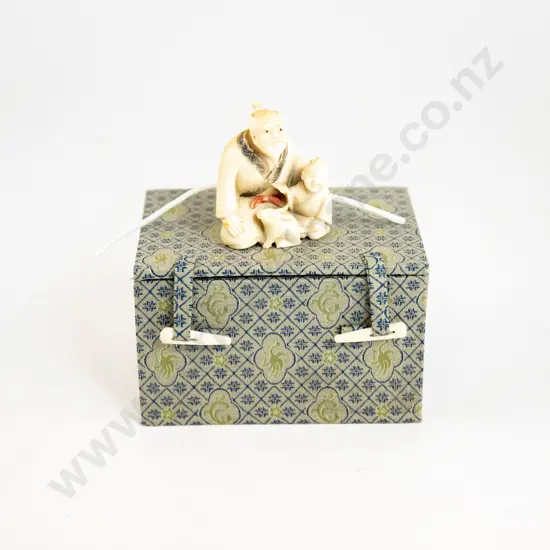 An Ivory Netsuke Of An Old Man A Boy And A Rabbit