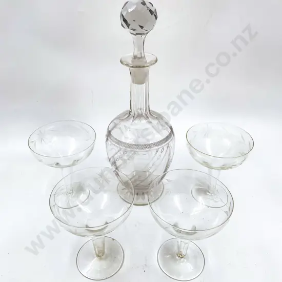 Etched Glass Decanter together with Four Hollow Stem Champagne Glasses