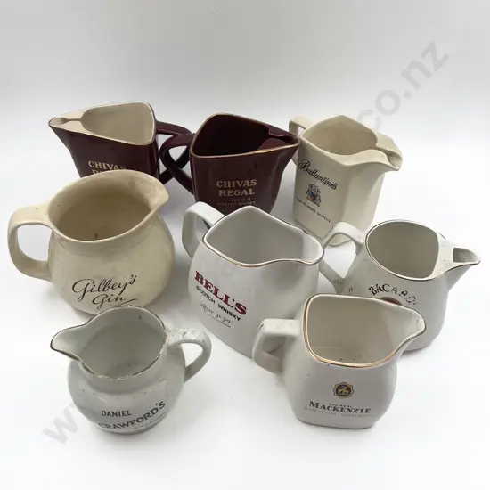 Eight Assorted Whisky Advertising Jugs