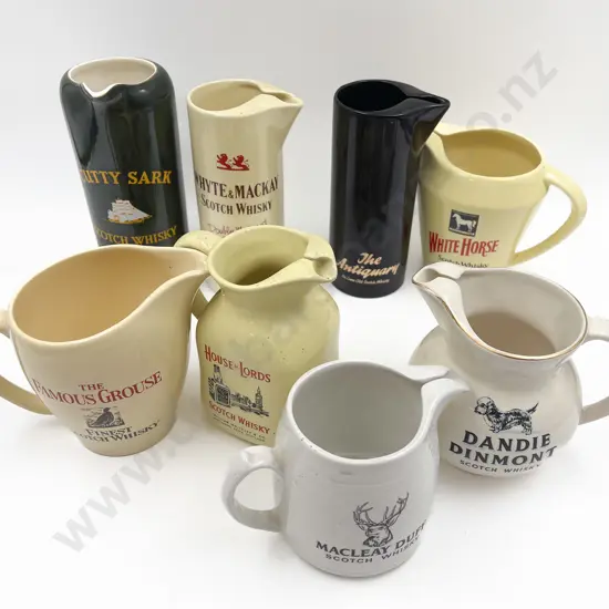 Eight Assorted Whisky Advertising Jugs