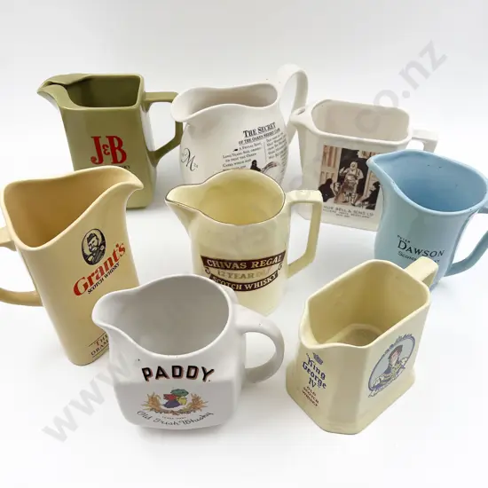 Eight Assorted Whisky Advertising Jugs