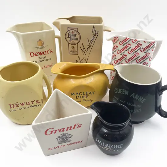 Eight Assorted Whisky Advertising Jugs