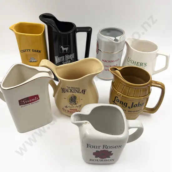 Eight Assorted Whisky Advertising Jugs