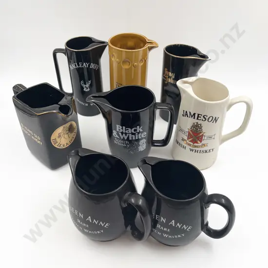 Eight Assorted Whisky Advertising Jugs