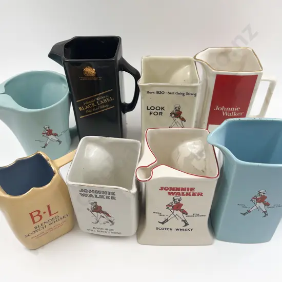 Eight Assorted Whisky Advertising Jugs