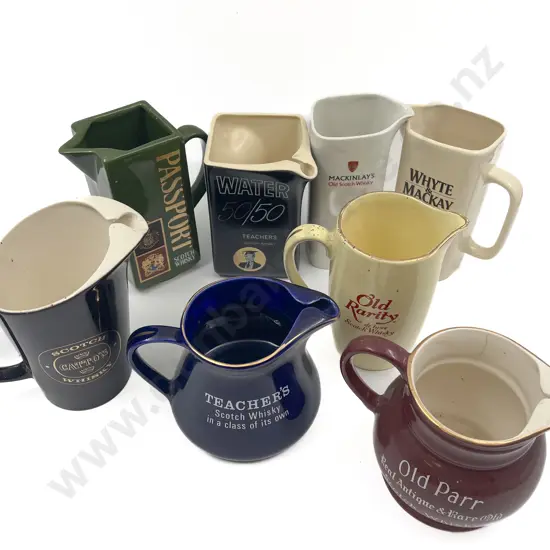 Eight Assorted Whisky Advertising Jugs