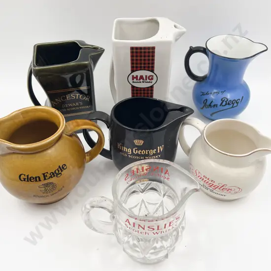 Seven Assorted Whisky Advertising Jugs