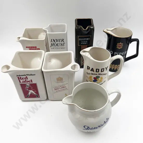 Eight Assorted Whisky Advertising Jugs