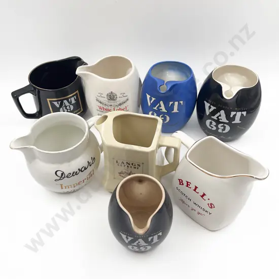 Eight Assorted Whisky Advertising Jugs