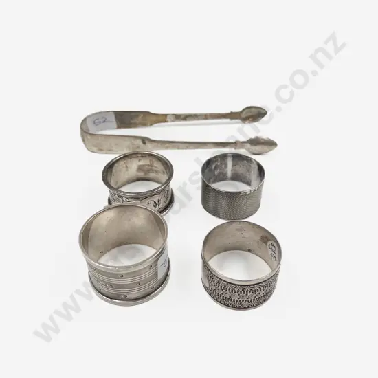 Four S/S Serviette Rings together with S/S Sugar Tongs