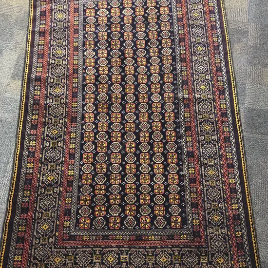 Afghani Woollen Floor Rug with Multiple Borders on a Dark Navy Ground