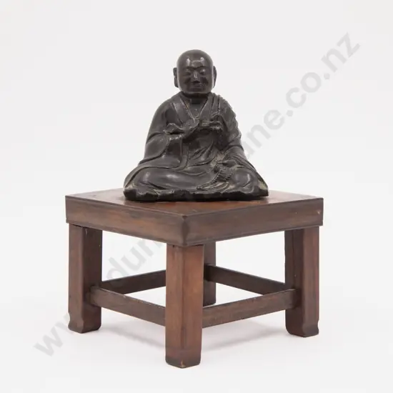 Bronze Figure of a Praying Young Tibetan Monk attached to wooden stand