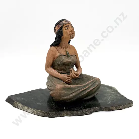 Seated Figure of Wahine on Greenstone Slab