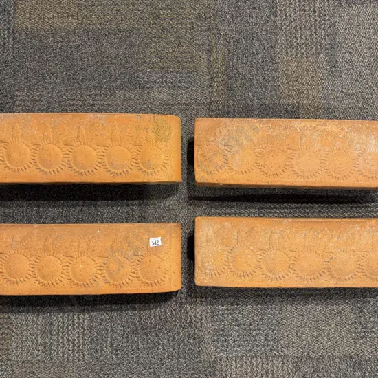 A Set of Four Slender Terracotta Planters