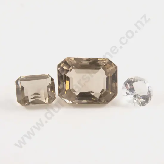 Three Unmounted Smoky Quartz and Crystal Gems