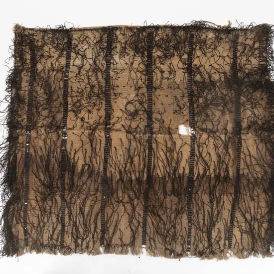 A large korowai (cloak) with hukahuka threads and vertical decorative bands