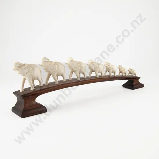 Carved Ivory Seven Elephant Bridge on Teak Stand